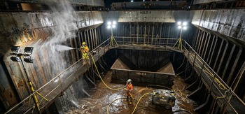 Cargo hold washing team operating chemical dosing pump